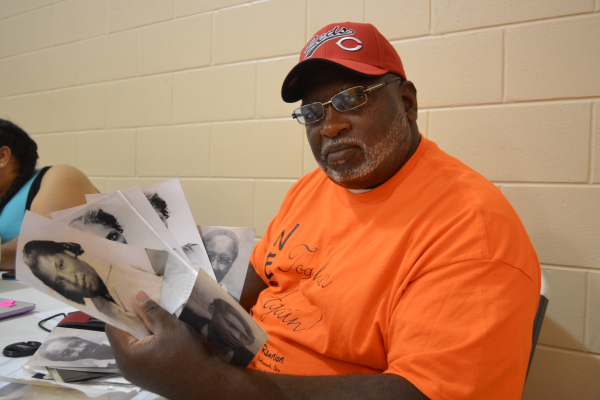 Roderick Wilson scans his family photographs at the North End Super Reunion, July 2017.