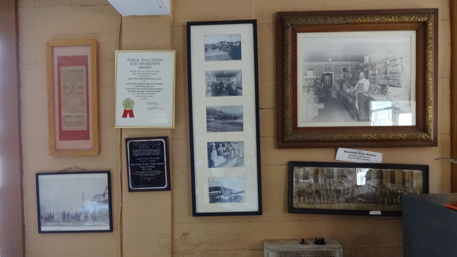 Photos and awards displayed on the wall of the Little Cities of Black Diamonds Council Office