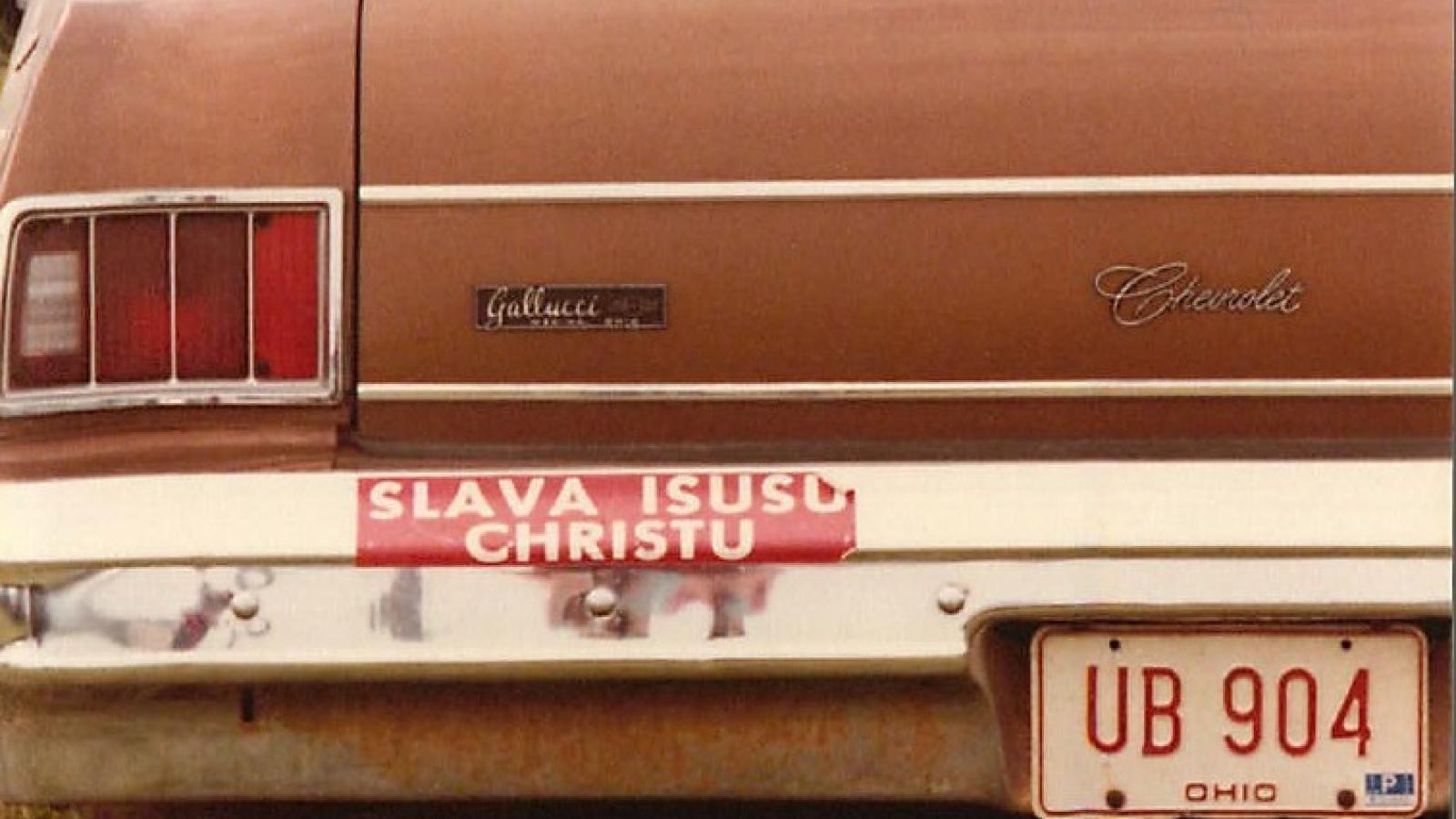 Bumper sticker reading "Glory to Jesus Christ" in Russian words with Latin script.