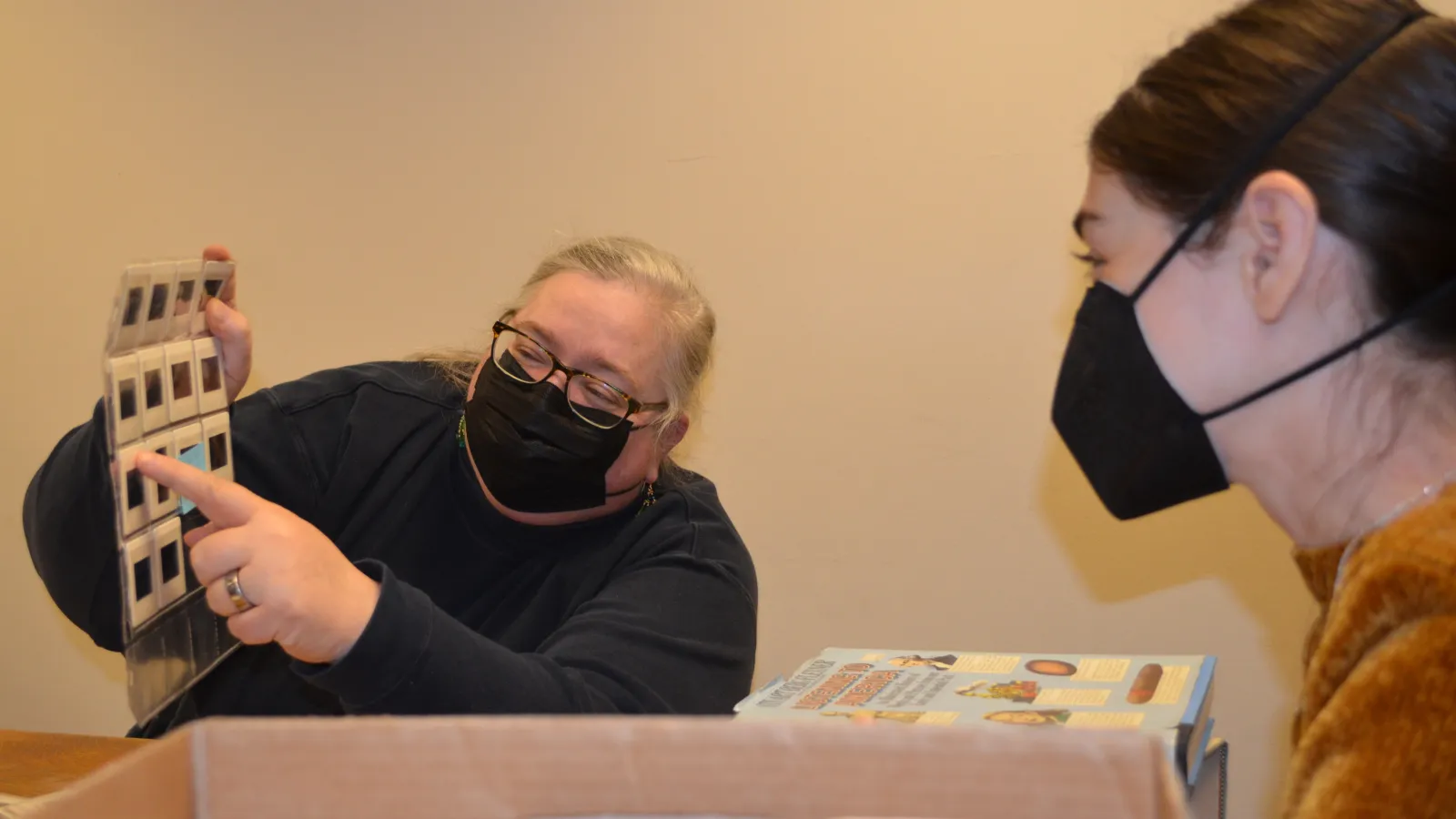 Karen Kieffer and Amelia Mathews-Pett, graduate student, examine slides