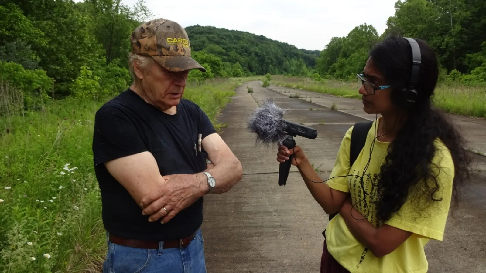 Shalini Abayasekara holding a recording device to Pete Crane