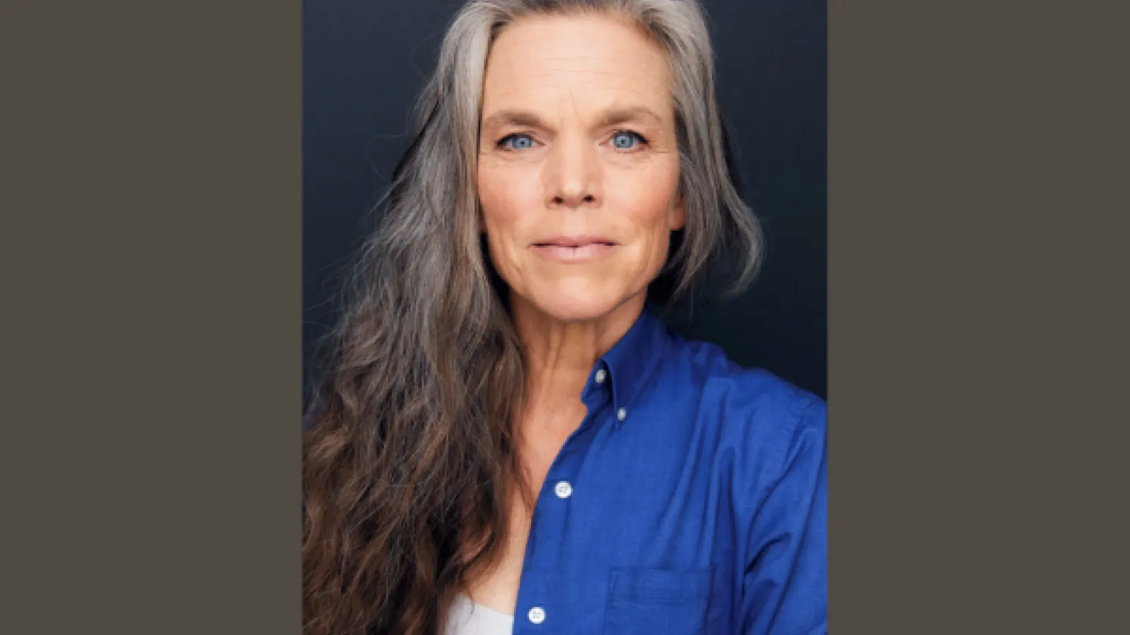 a portrait of a woman with long grey hair she is not smiling