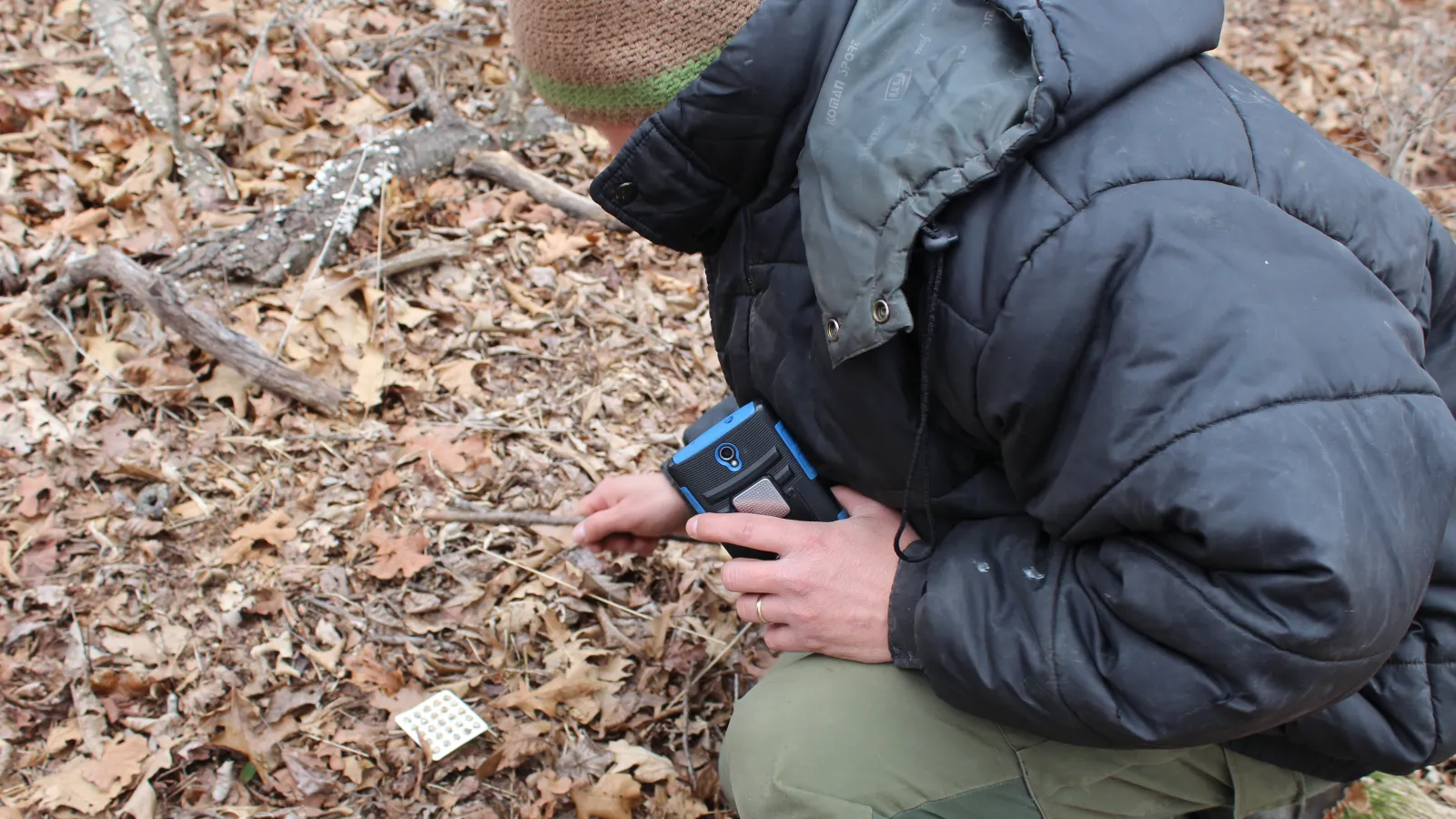 Josh Deemer stoops to pick up a bubble pack at "Floating Prairie".