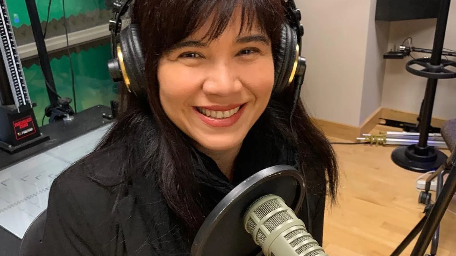 Elena Foulis in a sound recording studio with audio equipment.