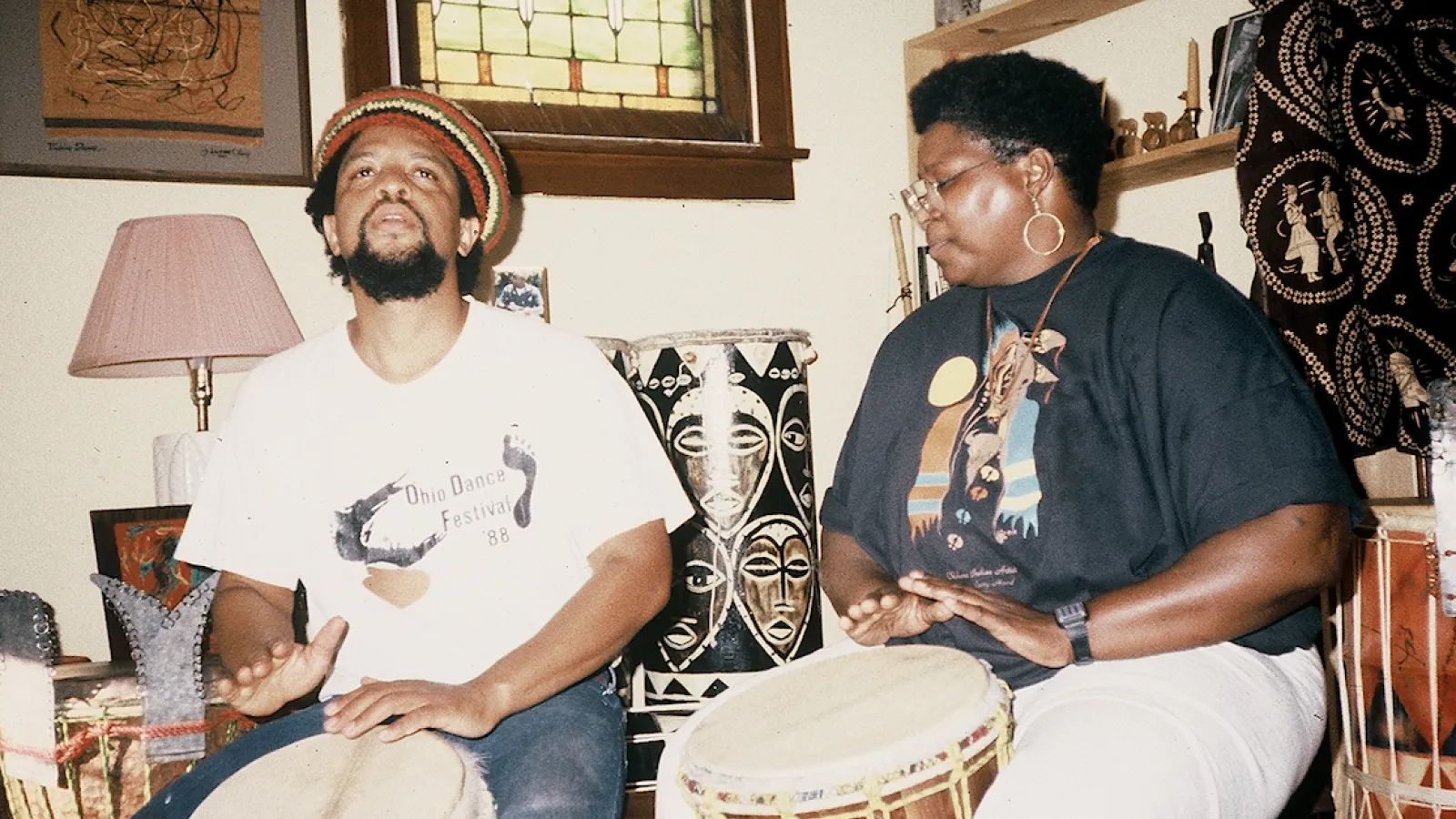 Harris playing drums with a woman
