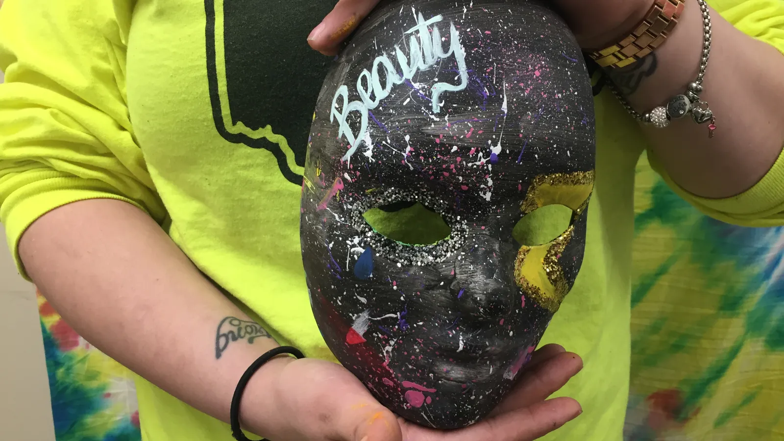 Close-up picture of Liv's art therapy mask as she holds it.