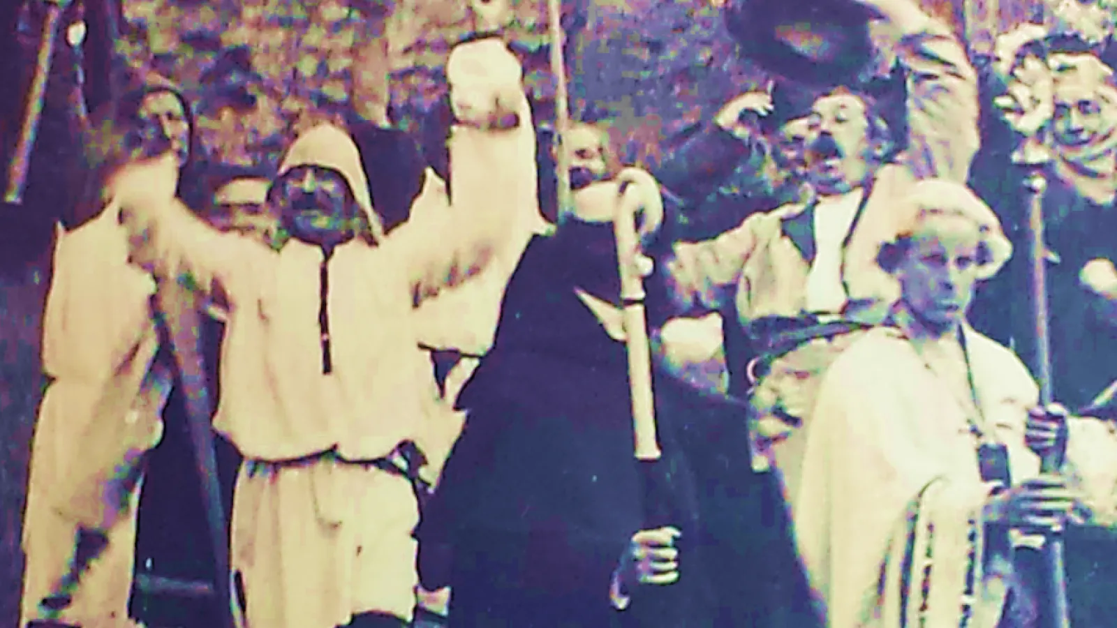 People in cloaks gathered