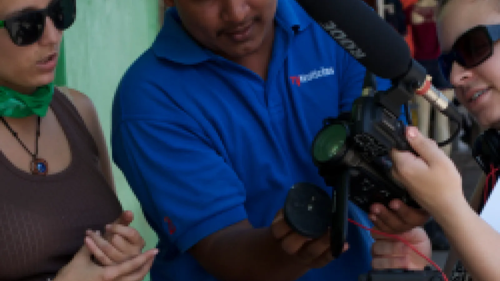 Three people filming in the strees of Bluefields, Nicaragua