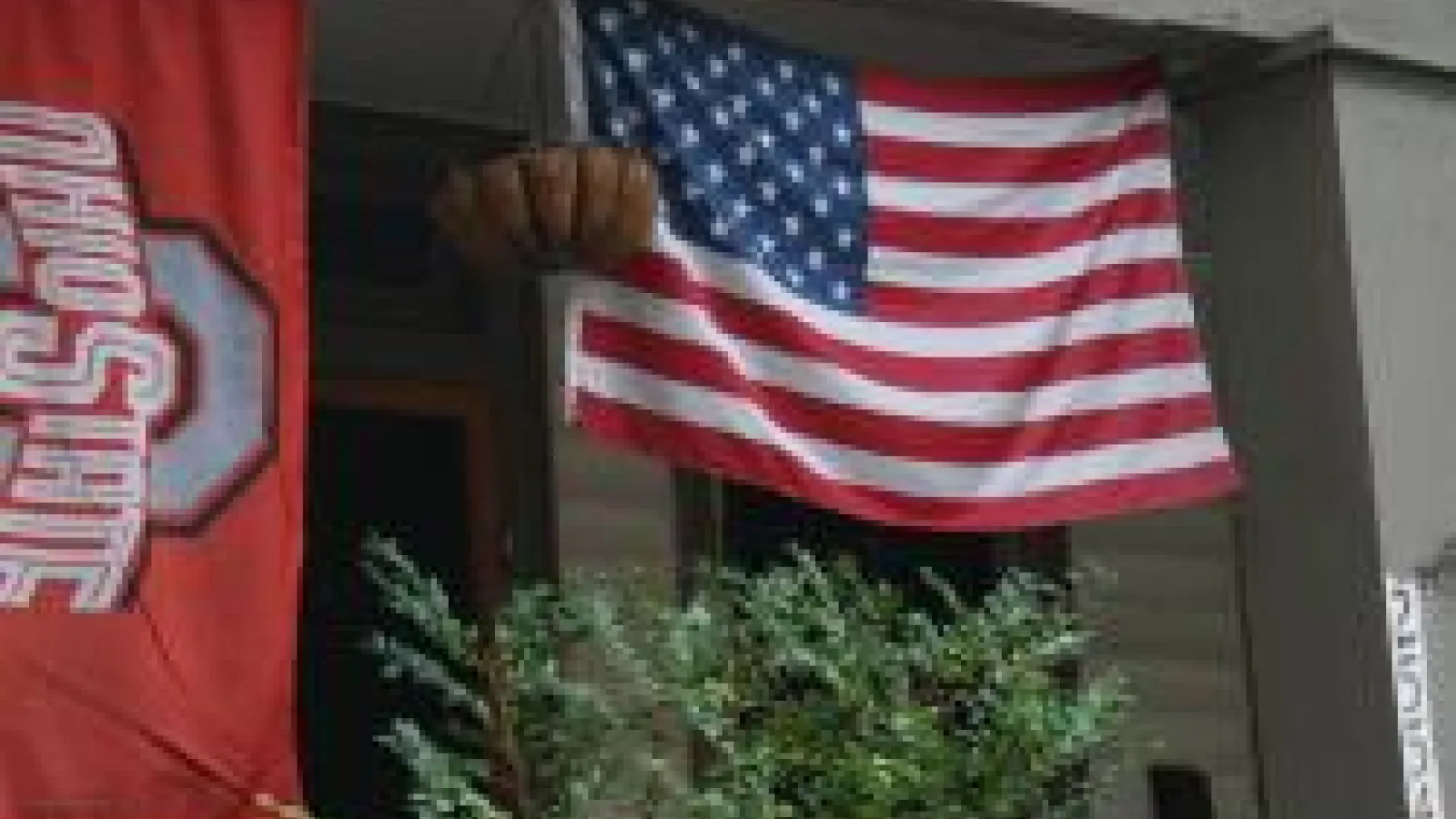 The Ohio State University flag hanging next to the American flag
