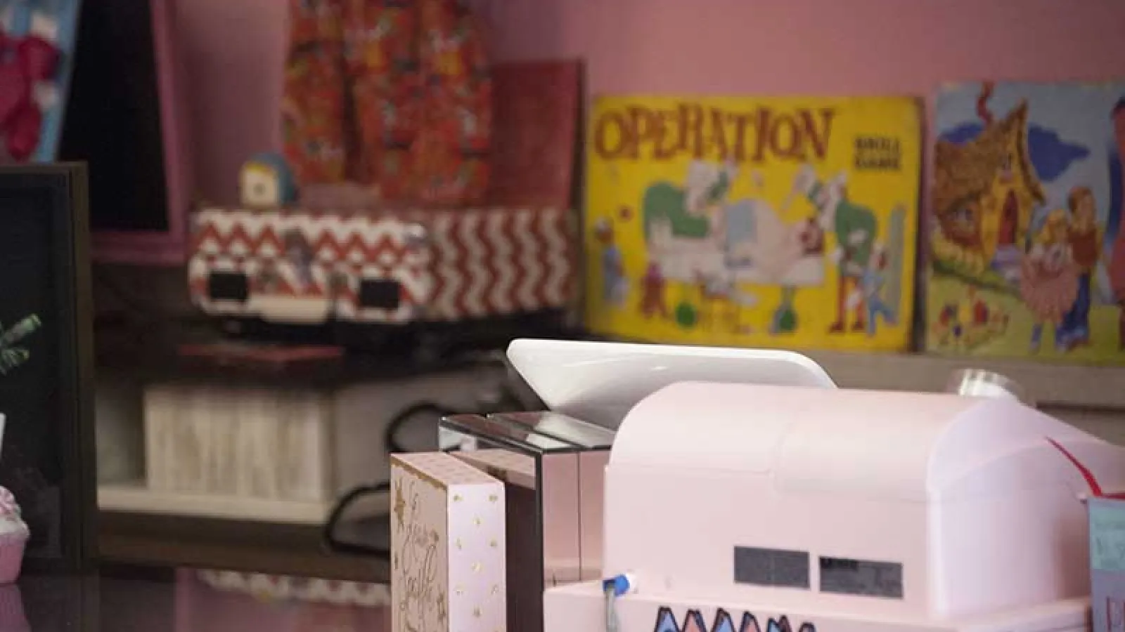 pink cash register and boardgames