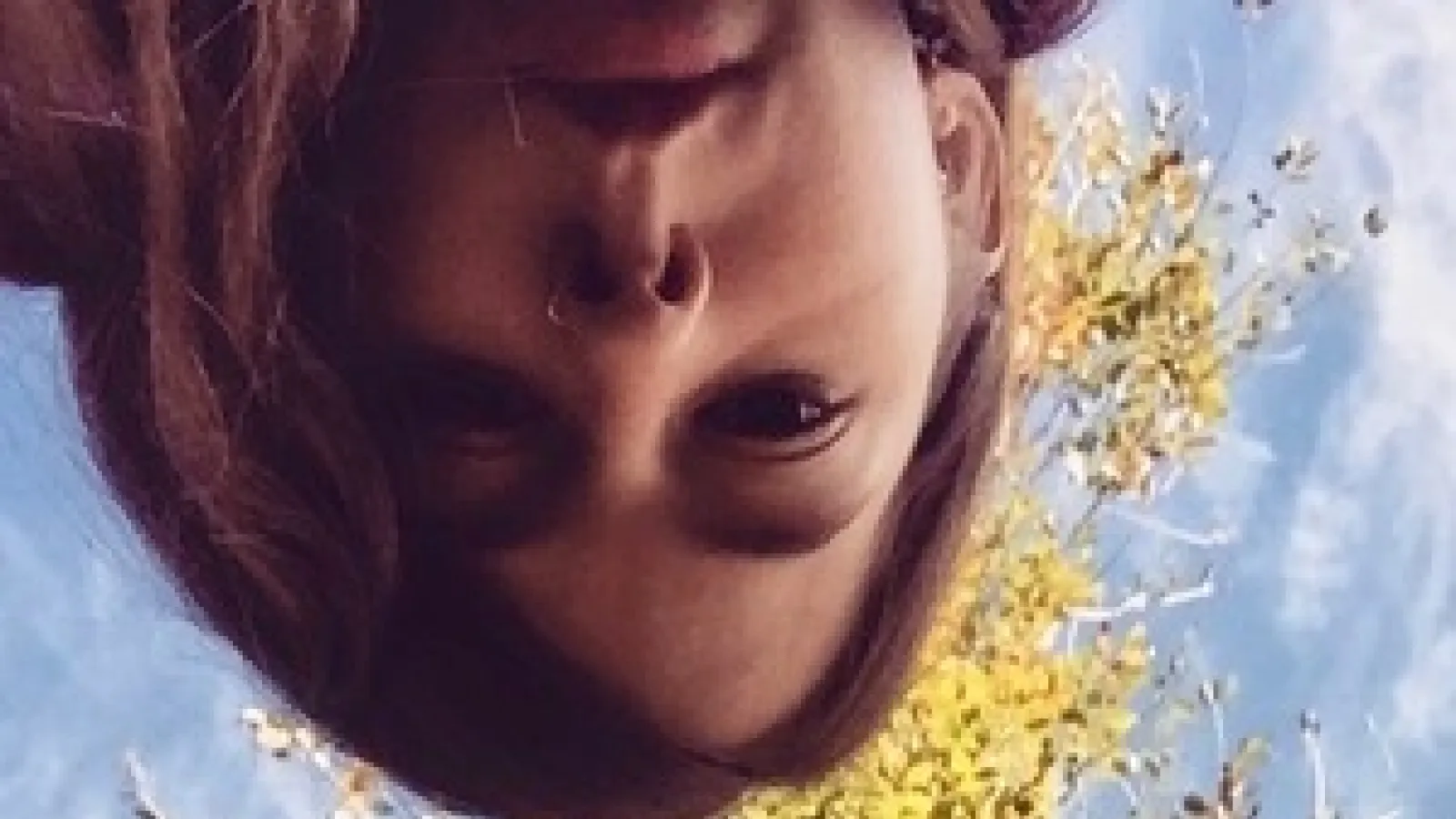 Headshot photo of Jordan Woodward with trees in the background.