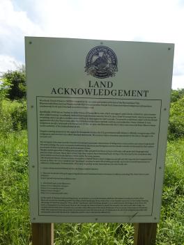 The land acknowledgement sign on Woodcock Nature Preserve