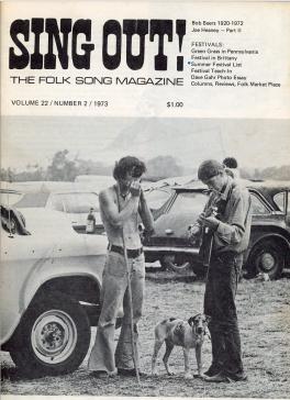 Cover of Sing Out! The Folk Song Magazine Vol 22 No 2 1973. Cover image shows two white men standing in a muddy parking lot with a dog in between them. One man is playing a harmonica and one man is playing the guitar and harmonica