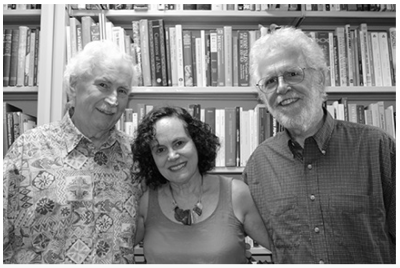 Dan Barnes, Amy Shuman, and Pat Mullen in front of display of books