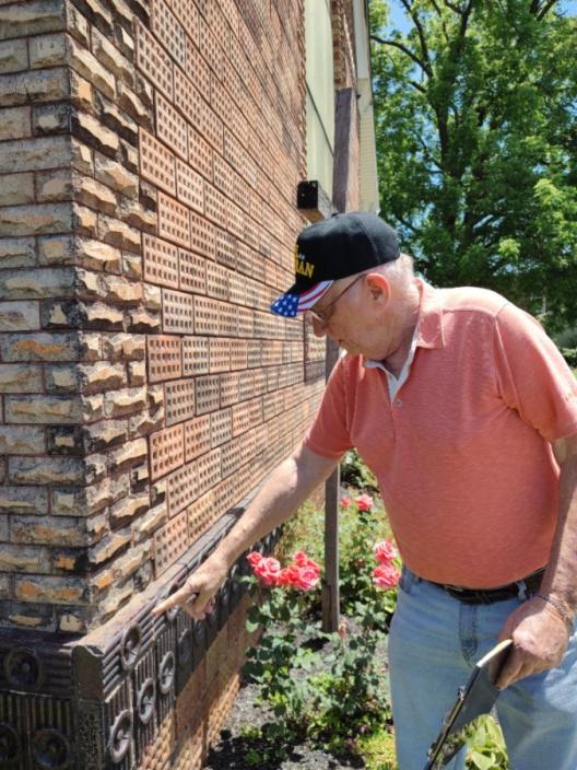 Larry Horn pointing towards a specific design on the Haydenville Methodist Church.