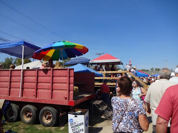 Fans sit on haybales and chairs in the backs of trailers and truck beds along near the backstretch.