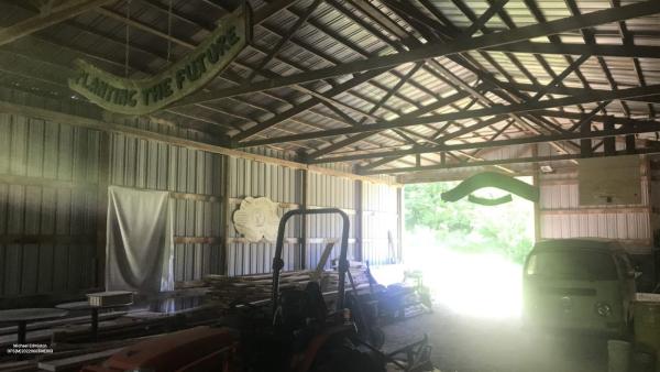 The interior of the UpS barn. The sign hanging from the ceiling reads: “Planting the Future"