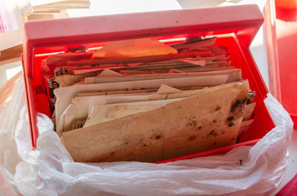 A plastic box of files that look dirty and moldy