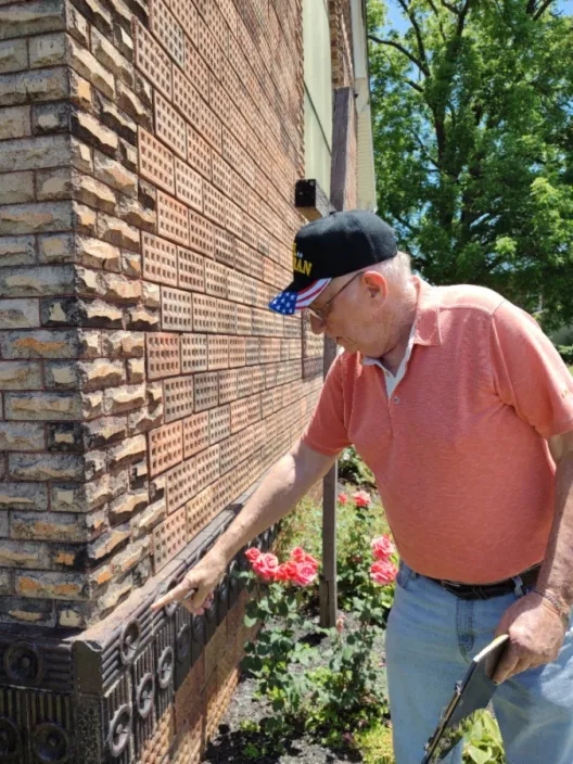 Larry Horn pointing towards a specific design on the Haydenville Methodist Church.