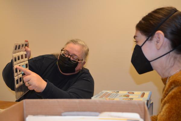 Karen Kieffer and Amelia Mathews-Pett, graduate student, examine slides