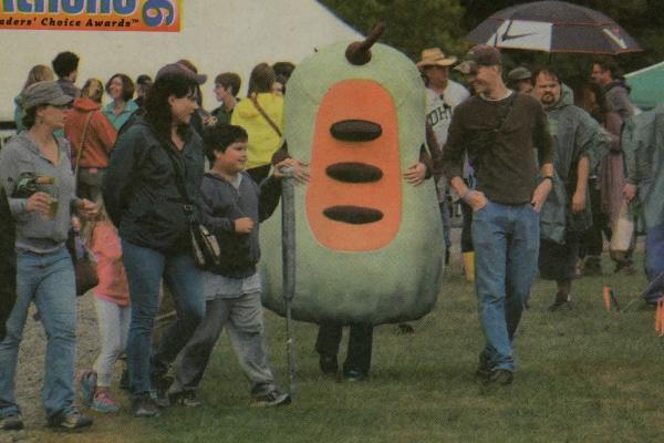 Image from a January 25, 2016 article about the Pawpaw Festival. The infamous pawpaw costume walks amongst festival-goers.