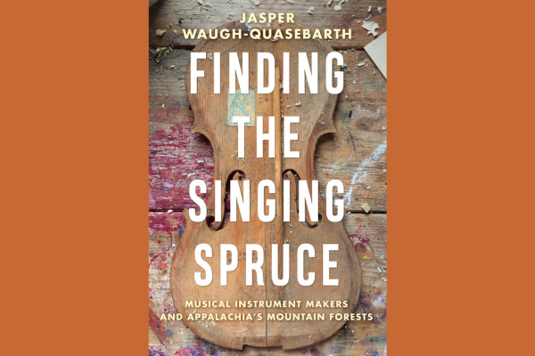 Finding the Singing Spruce Book title with a violin behind it