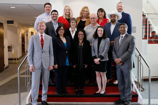 the recipients of the 2025 distinguished staff awards standing on stairs