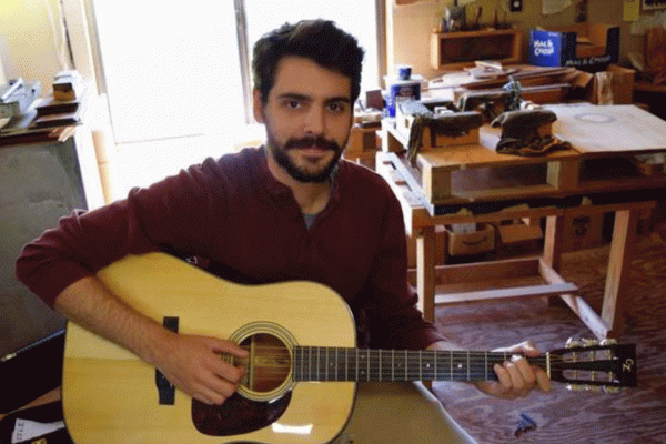 Jasper W-Q sits with guitar in hand. Jasper W-Q sits with guitar in hand.