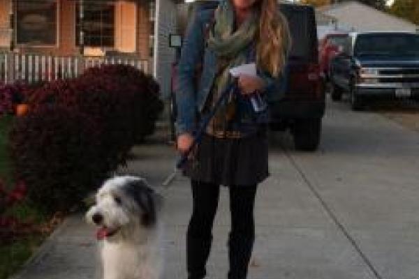 Kaitlyn Berle standing with a sheep dog