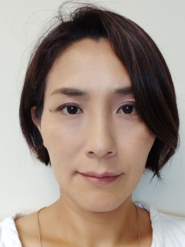 Headshot of an asian woman with a brown bob haircut