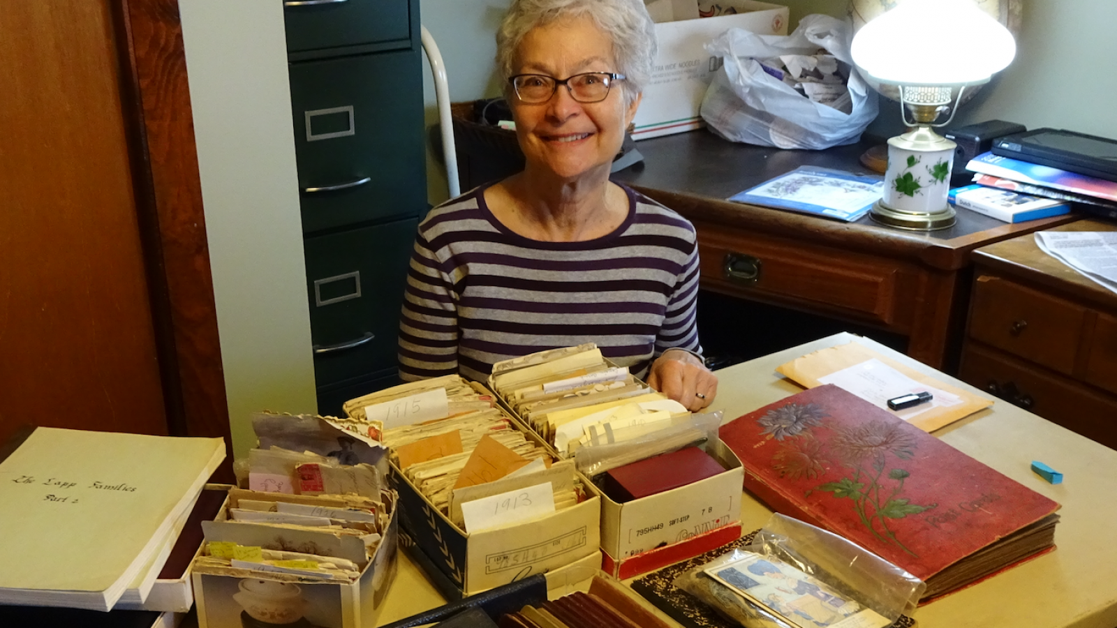 Barb Bradbury with collection of Lapp family documents in her home in Otway, Ohio. 