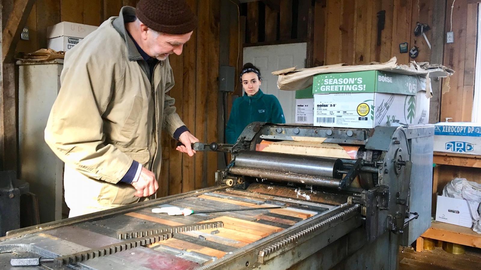 Brian Richards (left) explaining a step of the print process to Kinsey Hall (right).