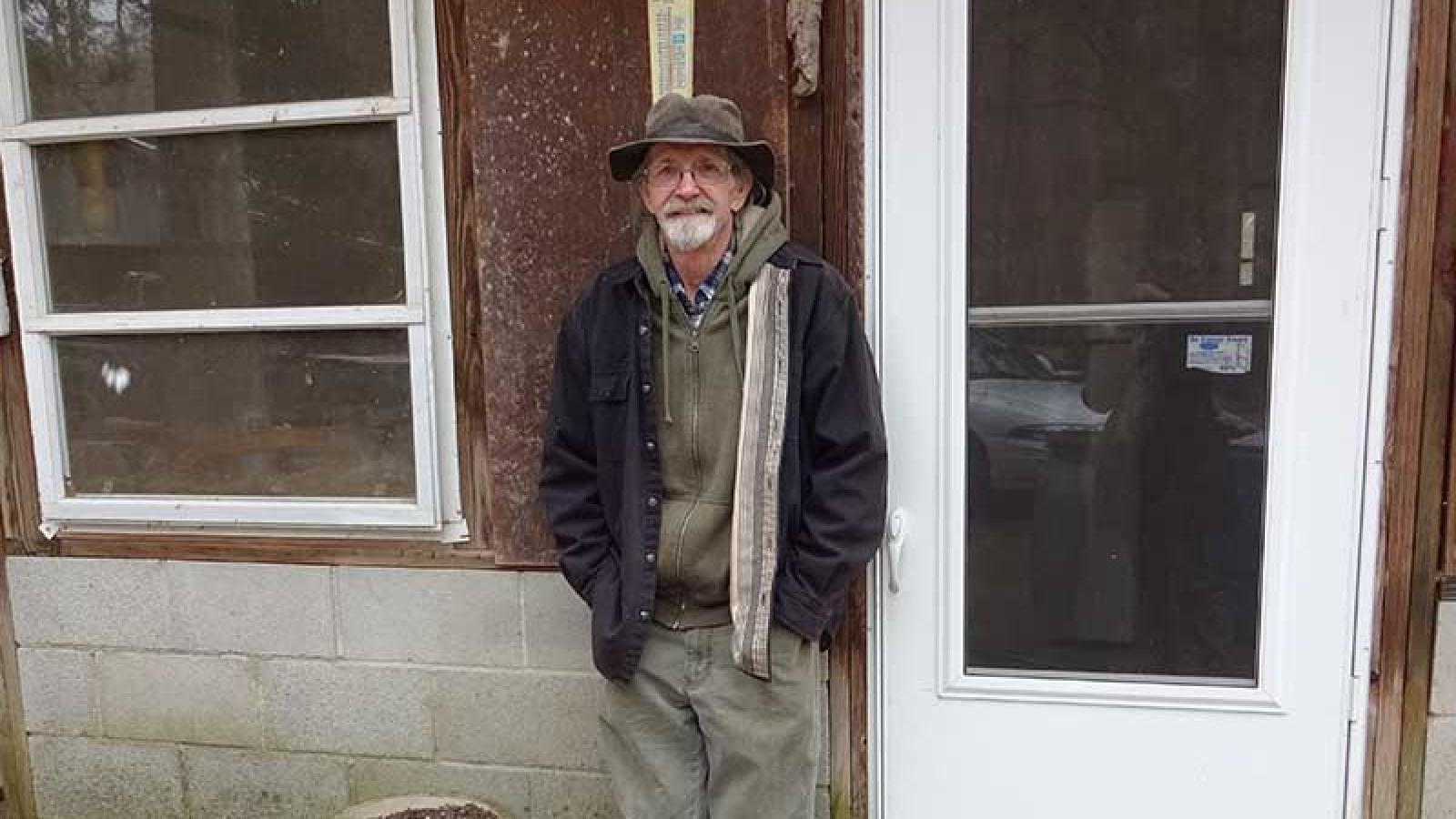 Ronny richards standing in front of his current house, built in 1983.